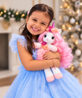Load image into Gallery viewer, Unicorn stuffed animal with long pink hair being hold dearly by a little girl dressed in a blue dress.

